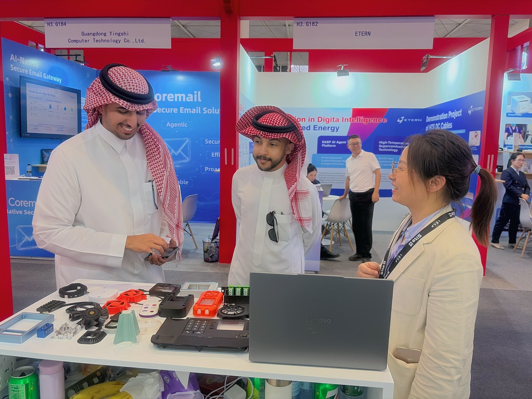A Rilong representative discussing molded product samples with visitors at LEAP 2026